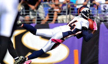 BALTIMORE, MD - OCTOBER 10:  Brandon Lloyd #84 of the Denver Broncos scores a touchdown against the Baltimore Ravens at M&T Bank Stadium on October 10, 2010 in Baltimore, Maryland. Players wore pink in recognition of Breast Cancer Awareness Month. The Rav