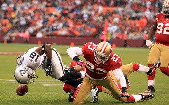 SAN FRANCISCO - OCTOBER 17:  Louis Murphy #18 of the Oakland Raiders fumbles the ball when he was hit by Taylor Mays #23 of the San Francisco 49ers at Candlestick Park on October 17, 2010 in San Francisco, California. Murphy recovered his own fumble on th