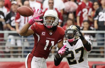 GLENDALE, AZ - OCTOBER 10:  Wide receiver Larry Fitzgerald #11 of the Arizona Cardinals attempts to catch a pass under pressure from Malcolm Jenkins #27 of the New Orleans Saints during the NFL game at the University of Phoenix Stadium on October 10, 2010