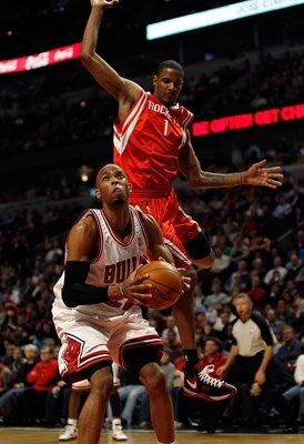 CHICAGO - MARCH 22: Taj Gibson #22 of the Chicago Bulls tries to shoot as Trevor Ariza #1 of the Houston Rockets leaps behind him at the United Center on March 22, 2010 in Chicago, Illinois. The Bulls defeated the Rockets 98-88. NOTE TO USER: User express