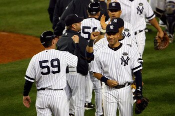 NEW YORK - OCTOBER 20:  Derek Jeter #2 of the New York Yankees celebrates with his teammates after the Yankees won 7-2 against the Texas Rangers in Game Five of the ALCS during the 2010 MLB Playoffs at Yankee Stadium on October 20, 2010 in the Bronx borou