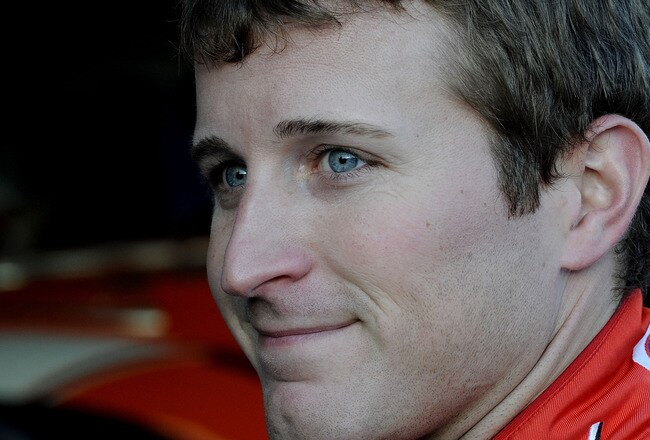 CONCORD, NC - OCTOBER 15:  Kasey Kahne, driver of the #9 Budweiser Ford, stands in the garage during practice for the NASCAR Sprint Cup Series Bank of America 500 at Charlotte Motor Speedway on October 15, 2010 in Concord, North Carolina.  (Photo by John