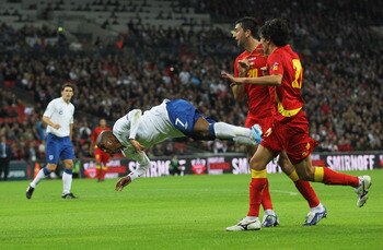 LONDON, ENGLAND - OCTOBER 12: Ashley Young of England goes to ground in the penalty area during the UEFA EURO 2012 Group G Qualifying match between England and Montenegro at Wembley Stadium on October 12, 2010 in London, England.  (Photo by Hamish Blair/G