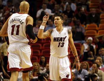 MIAMI - OCTOBER 18:  Center Zydrunas Ilgauskas #11 and Forward Mike Miller #13 of the Miami Heat celebrate against the Charlotte Bobcats on October 18, 2010 at American Airlines Arena in Miami, Florida. NOTE TO USER: User expressly acknowledges and agrees