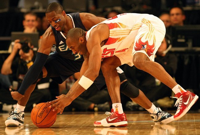 PHOENIX - FEBRUARY 15:  Dwyane Wade #3 of the Eastern Conference and Kobe Bryant #24 of the Western Conference go after a loose ball during the 58th NBA All-Star Game, part of 2009 NBA All-Star Weekend at US Airways Center on February 15, 2009 in Phoenix,