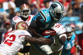 CHARLOTTE, NC - OCTOBER 24:  Teammates Patrick Willis #52 and Takeo Spikes #51 of the San Francisco 49ers tackle David Gettis #12 of the Carolina Panthers during their game at Bank of America Stadium on October 24, 2010 in Charlotte, North Carolina.  (Pho