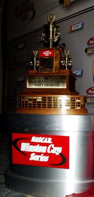 NEW YORK - DECEMBER 05: NASCAR driver Matt Kenseth and wife Katie pose with 1st place trophy in the press room during the 2003 NASCAR Winston Cup Awards at the Waldorf Astoria Hotel December 05, 2003 in New York City.   (Photo by Matthew Peyton/Getty Imag