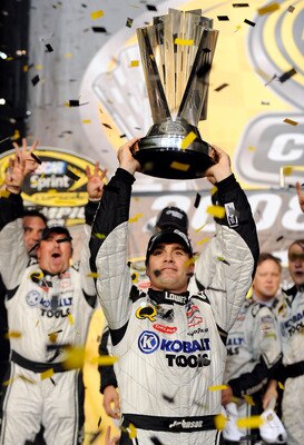 HOMESTEAD, FL - NOVEMBER 16:  Jimmie Johnson (R), driver of the #48 Lowe's/Kobalt Tools Chevrolet, holds up the trophy after winning the 2008 NASCAR Sprint Cup Series Championship after the Ford 400 at Homestead-Miami Speedway on November 16, 2008 in Home