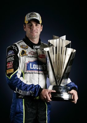HOMESTEAD, FL - NOVEMBER 19:  2006 NASCAR Nextel Cup Series Champion Jimmie Johnson, driver of the #48 Lowe's Chevrolet, poses with the Nextel Cup, following the NASCAR Nextel Cup Series Ford 400, on November 19, 2006 at Homestead-Miami Superspeedway  in