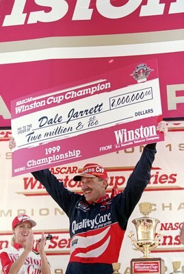 14 Nov 1999:  Dale Jarrett smiles and holds up his check after winning  the Pennzoil 400, part of the NASCAR Winston Cup Series, at the Homestead - Miami Speedway in Homestead, Florida. Mandatory Credit: Jon Ferrey  /Allsport