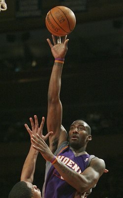 NEW YORK - JANUARY 24:  Amare Stoudemire #1 of the Phoenix Suns shoots over Channing Frye #7 of the New York Knicks January 24, 2007 at Madison Square Garden in New York City. NOTE TO USER: User expressly acknowledges and agrees that, by downloading and o