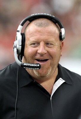 GLENDALE, AZ - SEPTEMBER 26:  Head coach Tom Cable of the Oakland Raiders smiles on the sidelines during the NFL game against the Arizona Cardinals at the University of Phoenix Stadium on September 26, 2010 in Glendale, Arizona.  The Cardinals defeated th