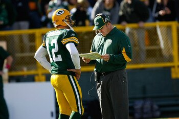 GREEN BAY, WI - OCTOBER 17: Aaron Rogers #12 of the Green Bay Packers talks with Mike McCarthy against the Miami Dolphins at Lambeau Field on October 17, 2010 in Green Bay, Wisconsin. The Dolphins defeated the Packers 23-20 in overtime. (Photo by Scott Bo