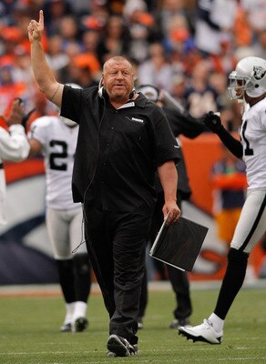 DENVER - OCTOBER 24:  Head coach Tom Cable of the Oakland Raiders signals for an extra point following a touchdown against the Denver Broncos in the first quarter at INVESCO Field at Mile High on October 24, 2010 in Denver, Colorado. The Raiders defeated