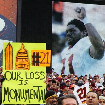 LANDOVER, MD - DECEMBER 02:  A fan of the Washington Redskins hold up a sign honoring the late Sean Taylor prior to the game against the Buffalo Bills on December 2, 2007 at FedEx Field in Landover, Maryland.  (Photo by Jim McIsaac/Getty Images)