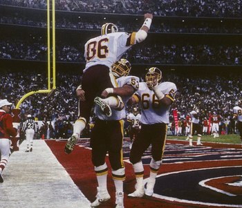 SAN DIEGO - JANUARY 31:  Tight end Clint Didier #86 (T) of the Washington Redskins celebrates with teammate Jeff Bostic #53 (B) after scoring a touchdown during Super Bowl XXII against the Denver Broncos at Jack Murphy Stadium on January 31, 1988 in San D