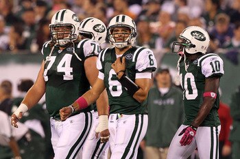 EAST RUTHERFORD, NJ - OCTOBER 11:  (L-R) Nick Mangold #74, Mark Sanchez #6 and Santonio Holmes #10 of the New York Jets walk on the field against the Minnesota Vikings at New Meadowlands Stadium on October 11, 2010 in East Rutherford, New Jersey. The Jets