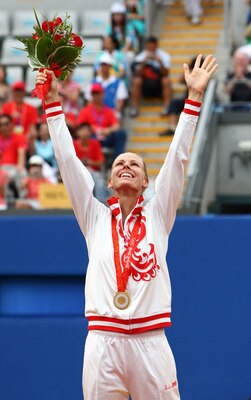 BEIJING - AUGUST 17:  Elena Dementieva of Russia celebrates winning the gold medal by defeating Dinara Safina of Russia in the Women's Singles gold medal match held at the Olympic Green Tennis Center during Day 9 of the Beijing 2008 Olympic Games on Augus