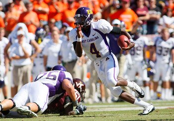 BLACKSBURG, VA - SEPTEMBER 18:  Quarterback Dominique Davis #4 of the East Carolina Pirates runs with the ball against the Virginia Tech Hokies at Lane Stadium on September 18, 2010 in Blacksburg, Virginia.  (Photo by Geoff Burke/Getty Images)