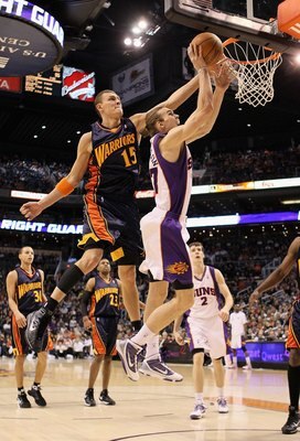 PHOENIX - JANUARY 23:  Louis Amundson #17 of the Phoenix Suns lays up a shot past Andris Biedrins #15 of the Golden State Warriors during the NBA game at US Airways Center on January 23, 2010 in Phoenix, Arizona.  The Suns defeated the Warriors 112-103.