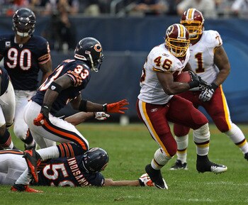 CHICAGO - OCTOBER 24: Ryan Torain #46 of the Washington Redskins runs past Pisa Tinoisamoa #59 of the Chicago Bears as Charles Tillman #33 closes in at Soldier Field on October 24, 2010 in Chicago, Illinois. The Redskins defeated the Bears 17-14. (Photo b