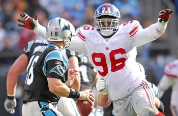 CHARLOTTE, NC - DECEMBER 10: Barry Cofield #96 of the New York Giants pressures quarterback Chris Weinke #16 of the Carolina Panthers during an NFL game on December 10, 2006, at Bank of America Stadium in Charlotte, North Carolina. (Photo By Grant Halvers