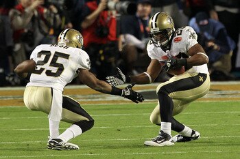 MIAMI GARDENS, FL - FEBRUARY 07:   Reggie Bush #25 celebrates with Pierre Thomas #23 of the New Orleans Saints after Thomas' touchdown during Super Bowl XLIV on February 7, 2010 at Sun Life Stadium in Miami Gardens, Florida.  (Photo by Ezra Shaw/Getty Ima