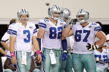 ARLINGTON, TX - OCTOBER 31:  (L-R) Jon Kitna #3, Jason Witten #82 and Phil Costa #67 of the Dallas Cowboys look on from the sideline late in the fourth quarter against the Jacksonville Jaguars at Cowboys Stadium on October 31, 2010 in Arlington, Texas.  (
