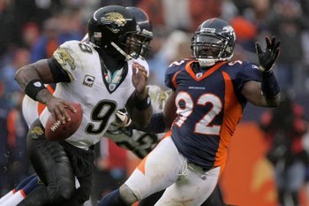 DENVER - OCTOBER 12:  Defensive end  Elvis Dumervil #92 of the Denver Broncos pressures quarterback David Garrard #9 of the Jacksonville Jaguars during NFL action at Invesco Field at Mile High on October 12, 2008 in Denver, Colorado. The Jaguars defeated 