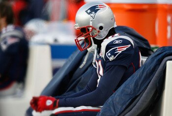 FOXBORO, MA - JANUARY 10:  Randy Moss #81 of the New England Patriots sits on the bench dejected late in the fourth quarter against the Baltimore Ravens during the 2010 AFC wild-card playoff game at Gillette Stadium on January 10, 2010 in Foxboro, Massach