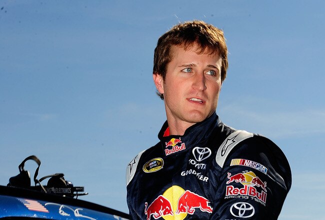 TALLADEGA, AL - OCTOBER 30:  Kasey Kahne, driver of the #83 Red Bull Toyota, climbs out of his car after qualifying for the NASCAR Sprint Cup Series AMP Energy Juice 500 at Talladega Superspeedway on October 30, 2010 in Talladega, Alabama.  (Photo by Rust