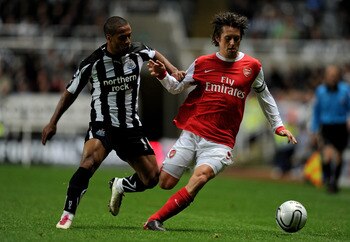 NEWCASTLE UPON TYNE, ENGLAND - OCTOBER 27:  Tomas Rosicky of Arsenal competes for the ball with Wayne Routledge of Newcastle United during the Carling Cup Fourth Round match between Newcastle United and Arsenal at St James' Park on October 27, 2010 in New
