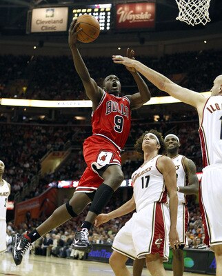 CLEVELAND - APRIL 19: Luol Deng #9 of the Chicago Bulls gets a shot off next to Anderson Varejao #17 and Zydrunas Ilgauskas #11 of the Cleveland Cavaliers in Game Two of the Eastern Conference Quarterfinals during the 2010 NBA Playoffs at Quicken Loans Ar