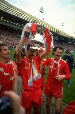 1986:  Craig Johnston (left), Ian Rush (centre) and Kevin MacDonald (right) all of Liverpool pose with the trophy after their victory in the the FA Cup final against Everton at Wembley Stadium in London. Liverpool won the match 3-1. \ Mandatory Credit: Da