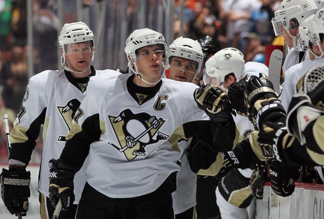 ANAHEIM, CA - NOVEMBER 05:  Sidney Crosby #87 of the Pittsburgh Penguins receives high fives from the bench after scoring a goal against the Anaheim Ducks in the third period at the Honda Center on November 5, 2010 in Anaheim, California. The Ducks defeat
