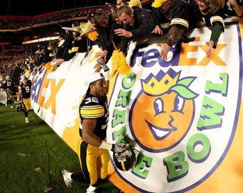 MIAMI GARDENS, FL - JANUARY 05:  Adam Robinson #32 of the Iowa Hawkeyes celebrates with fans after Iowa won 24-14 against the Georgia Tech Yellow Jackets during the FedEx Orange Bowl at Land Shark Stadium on January 5, 2010 in Miami Gardens, Florida.  (Ph