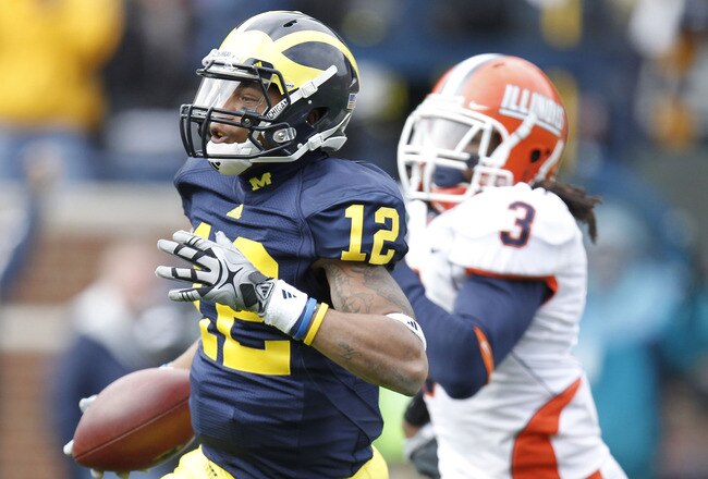 ANN ARBOR, MI - NOVEMBER 06:  Roy Roundtree #12 of the Michigan Wolverines gets past the tackle of Tavon Wilson #3 of the Illinios Fighting Illini after a second quarter reception at Michigan Stadium on November 6, 2010 in Ann Arbor, Michigan.  (Photo by
