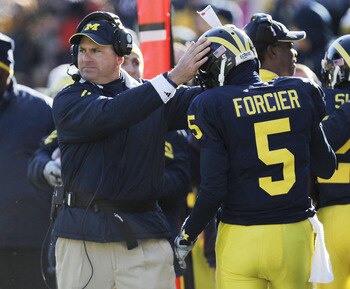 ANN ARBOR, MI - NOVEMBER 06:  Tate Forcier #5 of the Michigan Wolverines is congratulated by head coach Rich Rodriguez after scoring an overtime touchdown while playing the Illinios Fighting Illini at Michigan Stadium on November 6, 2010 in Ann Arbor, Mic