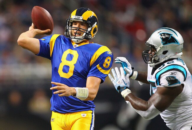ST. LOUIS - OCTOBER 31: Sam Bradford #8 of the St. Louis Rams looks to pass against Eric Norwood #92 of the Carolina Panthers at the Edward Jones Dome on October 31, 2010 in St. Louis, Missouri.  The Rams beat the Panthers 20-10.  (Photo by Dilip Vishwana