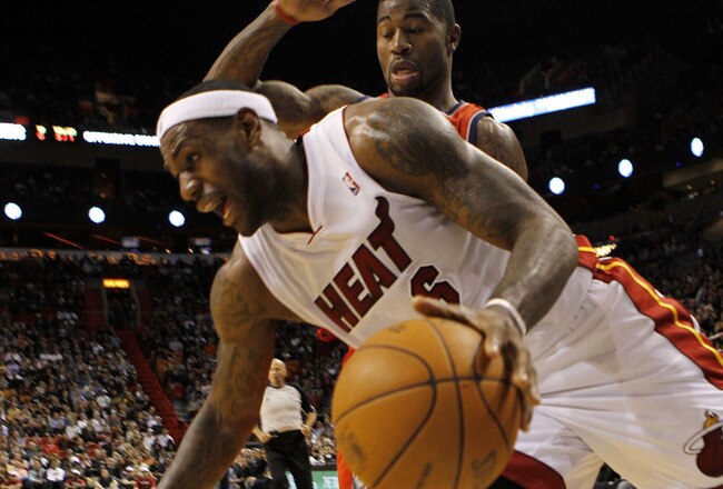 MIAMI - NOVEMBER 06:  Forward LeBron James #6 of the Miami Heat drives against guard Terrence Williams #1 of the New Jersey Nets  at American Airlines Arena on November 6, 2010 in Miami, Florida. NOTE TO USER: User expressly acknowledges and agrees that,