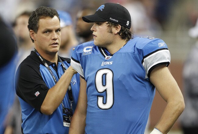 DETROIT - NOVEMBER 07: Detroit Lions team doctor Kyle Anderson checks the right shoulder of Matthew Stafford #9 of the Detroit Lions after leaving the game during the third quarter of the game at Ford Field on November 7, 2010 in Detroit, Michigan. The Je