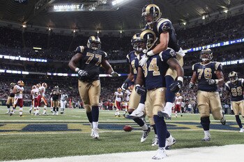 The St. Louis Rams celebrate in the end zone on the way to victory.
