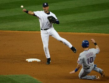 NEW YORK - OCTOBER 20:  Derek Jeter #2 of the New York Yankees turns a successful double play over a sliding Michael Young #10 of the Texas Rangers on a ball hit by Josh Hamilton #32 in the top of the fifth inning of Game Five of the ALCS during the 2010 
