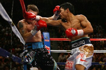 LAS VEGAS - MAY 02:  (R-L) Manny Pacquiao of the Philippines connects with a right to the face of Ricky Hatton of England in the first round of their junior welterweight title fight at the MGM Grand Garden Arena May 2, 2009 in Las Vegas, Nevada. Pacquiao