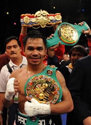 LAS VEGAS - JUNE 28:  Manny Pacquiao of the Philippines poses with his belts after he knocks out David Diaz during the ninth round of the WBC Lightweight Championship at the Mandalay Bay Events Center on June 28, 2008 in Las Vegas, Nevada.  (Photo by Harr