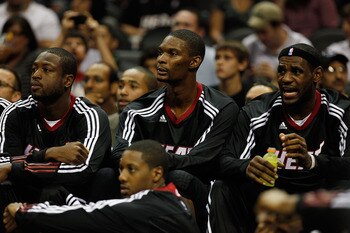 SAN ANTONIO - OCTOBER 09:  Dwayne Wade #3, Chris Bosh #1 and LeBron James #6 of the Miami Heat sit on the bench during the game against the San Antonio Spurs at the AT&T Center on October 9, 2010 in San Antonio, Texas.  NOTE TO USER: User expressly acknow