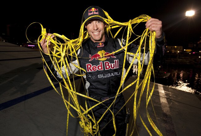 LONG BEACH, CA - DECEMBER 31: In this handout image provided by Red Bull Photofiles, Travis Pastrana poses after breaking the world record for the longest distance jump in a rally car on December 31, 2009 in Long Beach, California. The ramp to ramp jump w