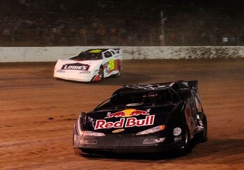 ROSSBURG, OH - JUNE 09:  Travis Pastrana, driver of the #199 Red Bull late model Subaru, leads Jimmie Johnson, driver of the #48 Lowes late model Chevrolet, through turn three during the Gillette Fusion ProGlide Prelude to the Dream at Eldora Speedway on