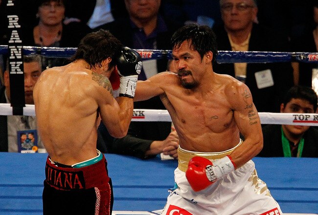 ARLINGTON, TX - NOVEMBER 13:  Manny Pacquiao (white trunks) of the Philippines fights against Antonio Margarito (black trunks) of Mexico during their WBC World Super Welterweight Title bout at Cowboys Stadium on November 13, 2010 in Arlington, Texas.  (Ph