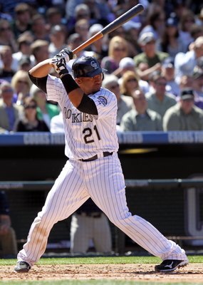 DENVER - APRIL 09:  Catcher Miguel Olivo #21 of the Colorado Rockies takes an at bat against the San Diego Padres during MLB action on Opening Day at Coors Field on April 9, 2010 in Denver, Colorado. The Rockies defeated the Padres 7-0.  (Photo by Doug Pe